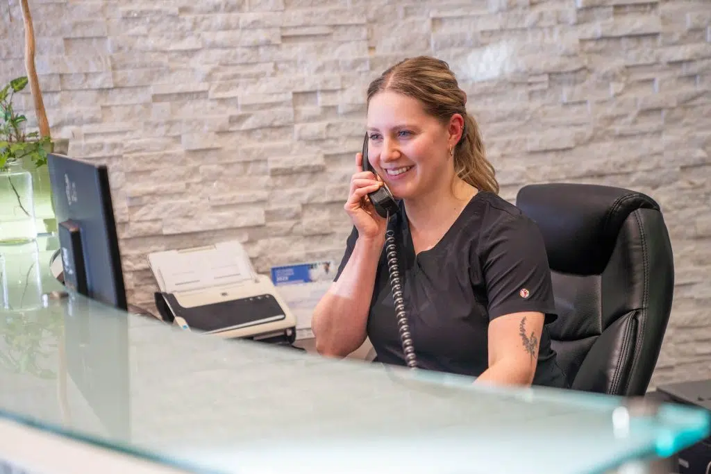woman answering the phone at dental office